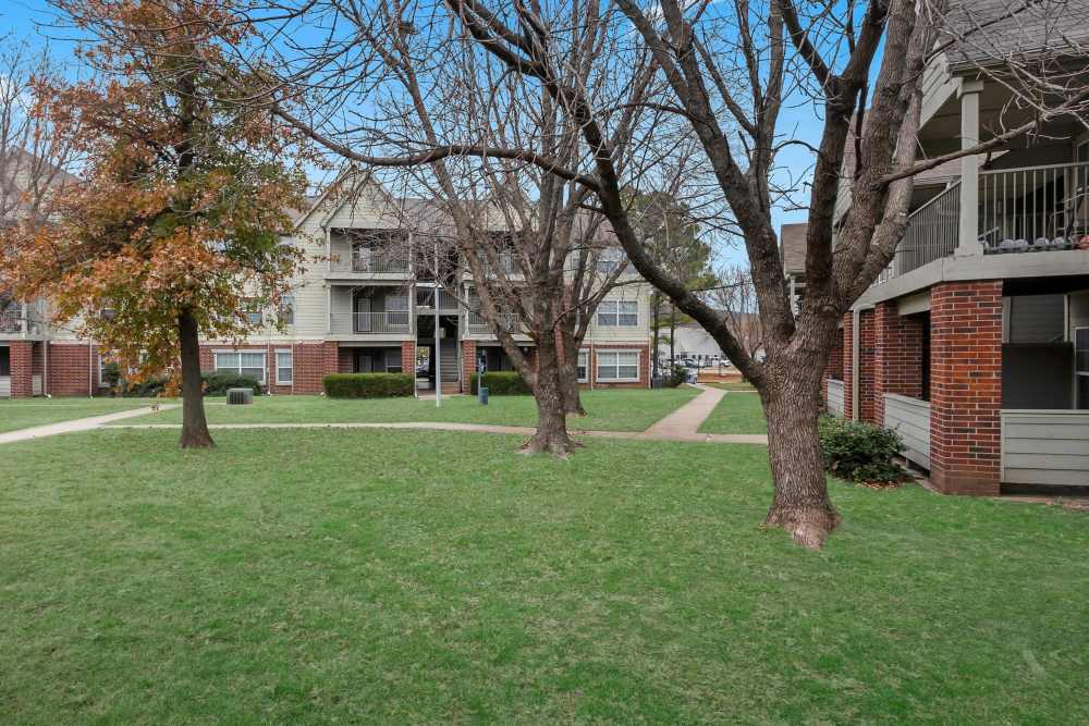 Exterior of the community with beautiful green lawn at Garden Courtyards in Tulsa, Oklahoma