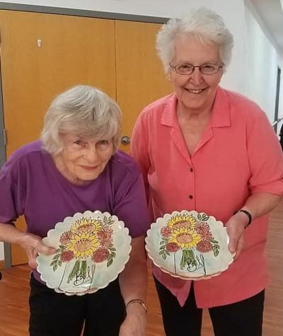 Residents showing off their creations from craft class at Garden Place Waterloo in Waterloo, Illinois.