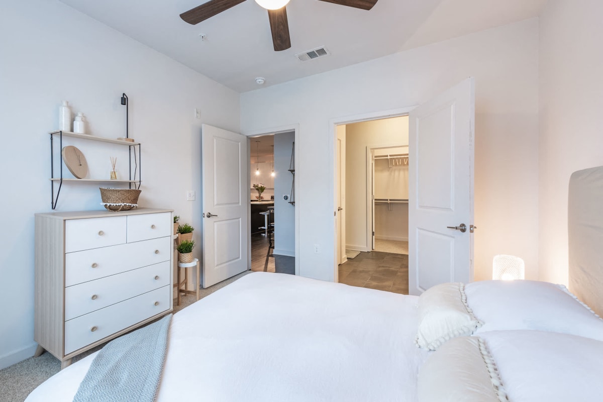 Apartment bedroom with a walk-in closet at Station R Apartments in Atlanta, Georgia