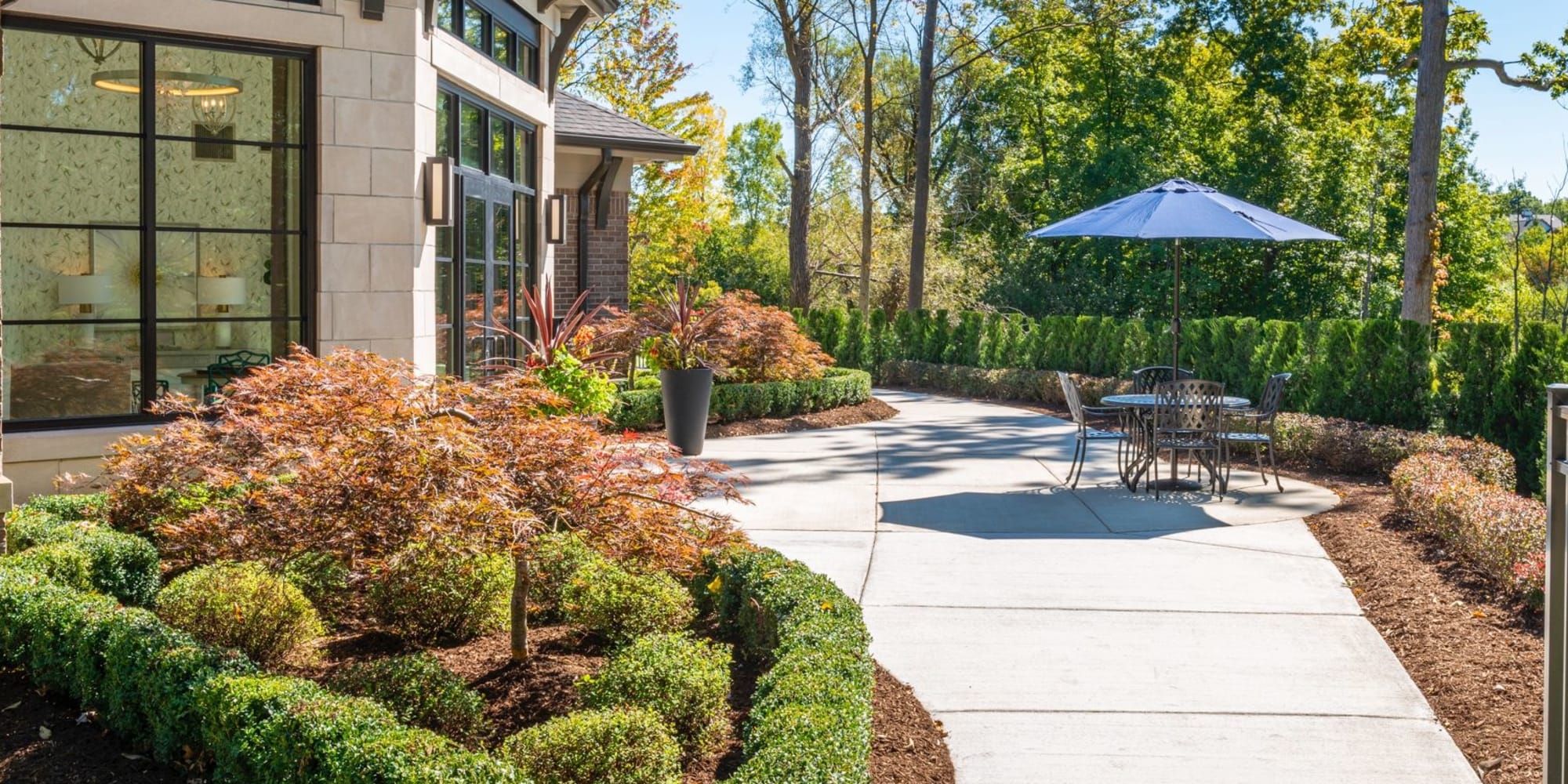 Elegant hedges with path and patio seating at Blossom Springs in Oakland Twp, Michigan