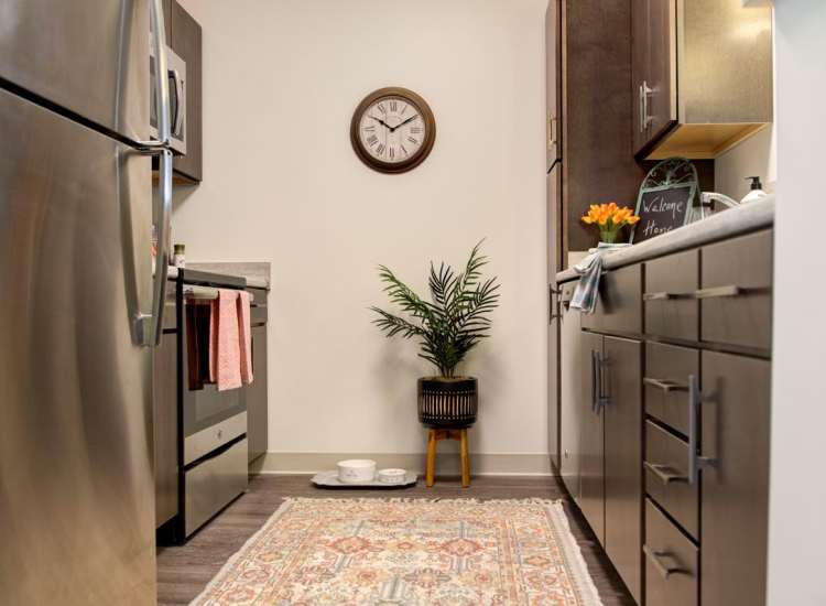 Modern kitchen with stainless-steel appliances and wood-style flooring at Gateway North in Lynn, Massachusetts