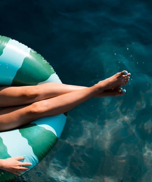 Resident on floatie in pool at Bay on 6th, Santa Monica, California 