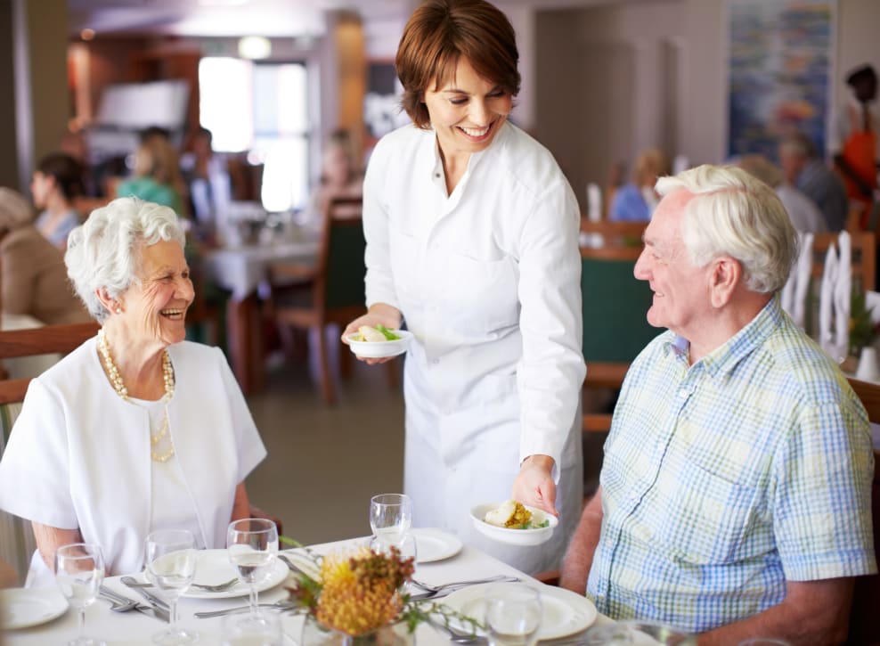 Staff serving desert in dining cafe to residents at Murano in Seattle, Washington