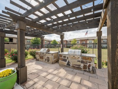 Patio table and grilling stations near the pool at Anatole at City View in Lubbock, Texas