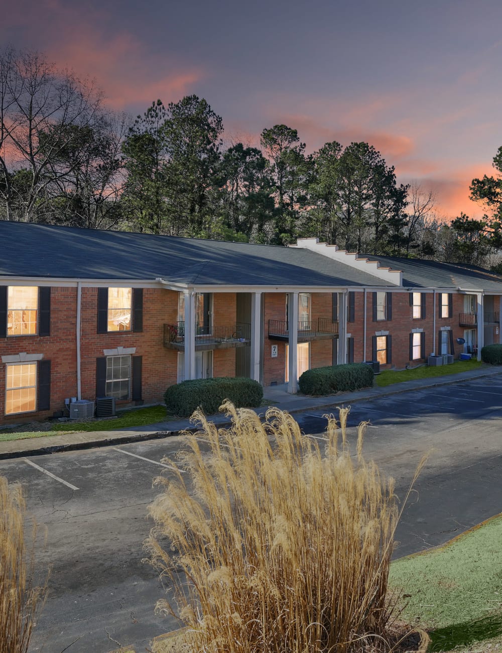 Exterior of an apartment building at twilight at Residence at Riverside in Austell, Georgia