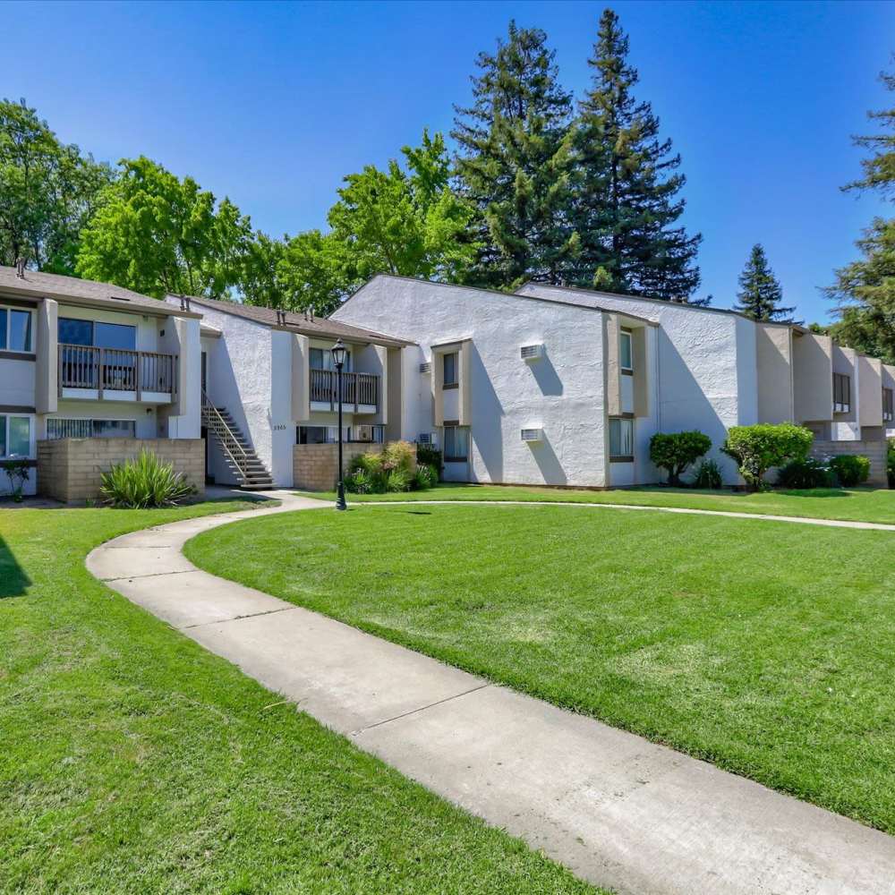 Beautiful community exterior view with pathway at Santa Teresa Apartments in San Jose, California