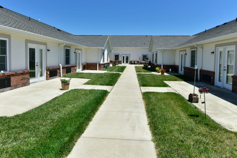 Lush greenery with walkway at Garden Place Waterloo in Waterloo, Illinois. 