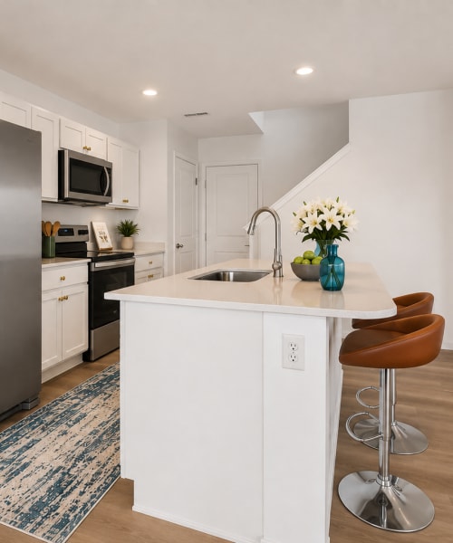 White kitchen cabinets and stainless steel appliances at Brixin Sonora in Fort Wayne, Indiana