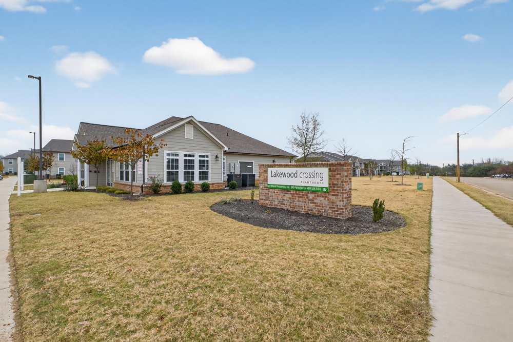 Charming community entrance with inviting landscaping at Lakewood Crossing in Granbury, Texas.
