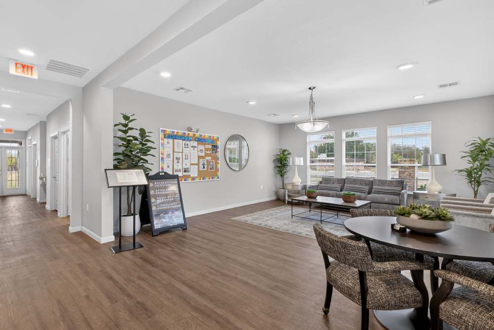 Spacious and inviting common area at Lakewood Crossing in Granbury, Texas, featuring stylish decor, ample natural light, and lush greenery.