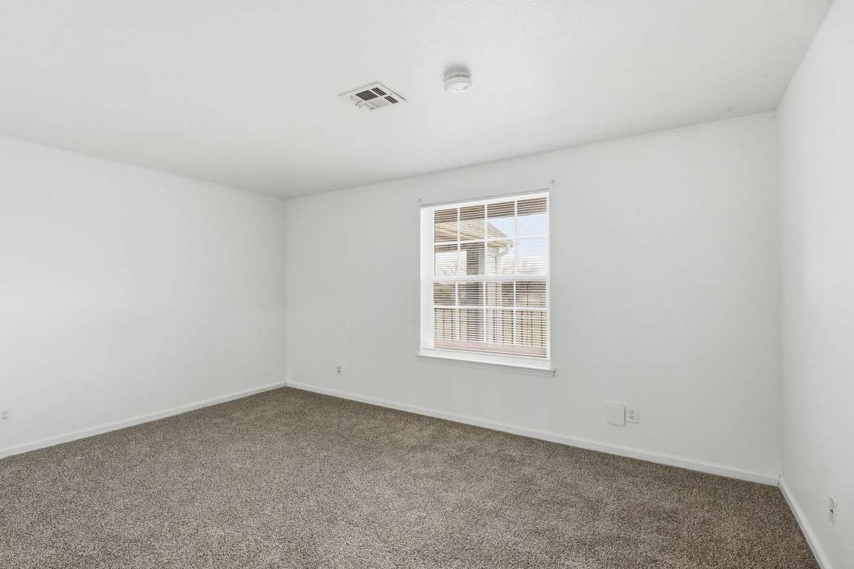 Living room with carpet floor at Parkford Apartments in Iola, Kansas