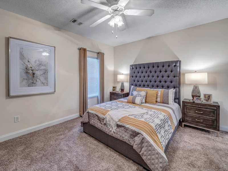 A furnished model bedroom at Adrian On Riverside in Macon, Georgia