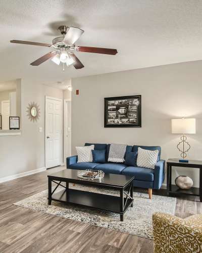 Living room with a fancy ceiling fan at Leaf Stone Apartments in Covington, Georgia
