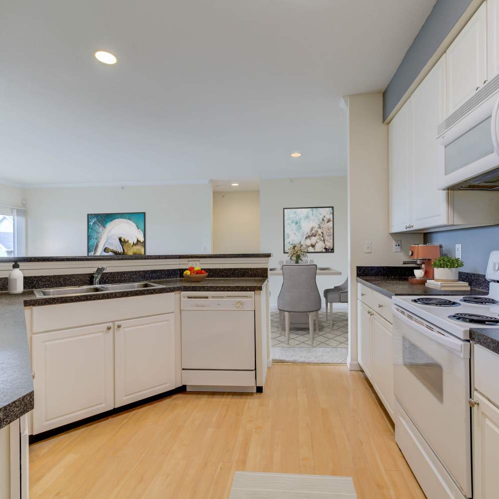 Modern kitchen with sleek countertops and bright open space at Boulder Springs in Maryland Heights, Missouri.