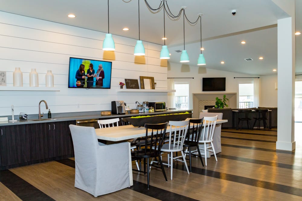 A community  kitchen with bar seating at Metro on 5th in Saint Charles, Missouri