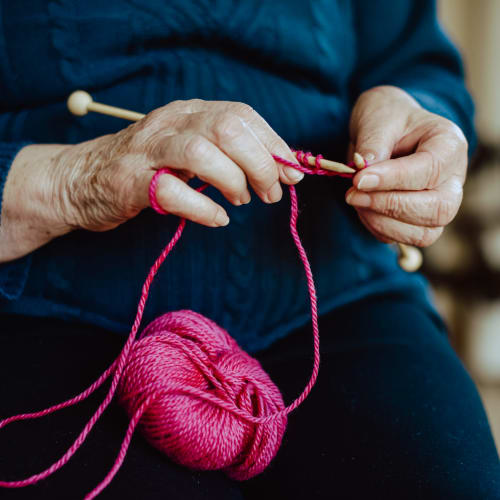 resident knitting at Oxford Springs Tulsa Memory Care in Tulsa, Oklahoma