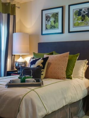 Elegant model master bedroom with plush carpeting at The BLVD in San Angelo, Texas