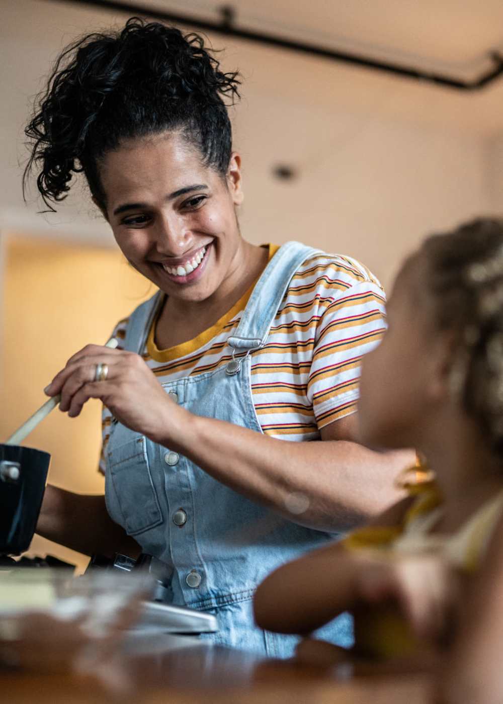 Resident with his daughter cooking in the kitchen at Ridge Commons in Lafayette, Louisiana