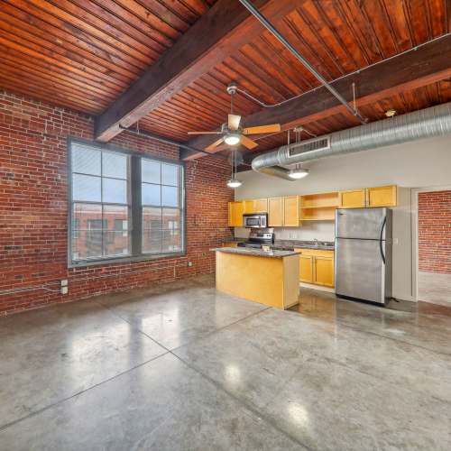 Unfurnished living room with large window at Stadium Loft Apartments in Saint Louis, Missouri