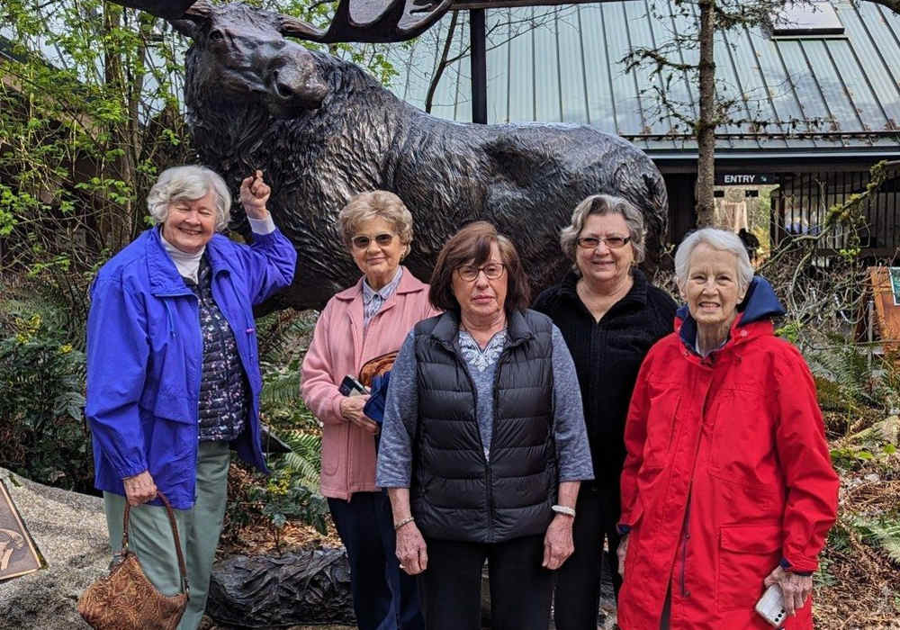 Residents posing in a garden near Merrill Gardens at Tacoma in Tacoma, Washington