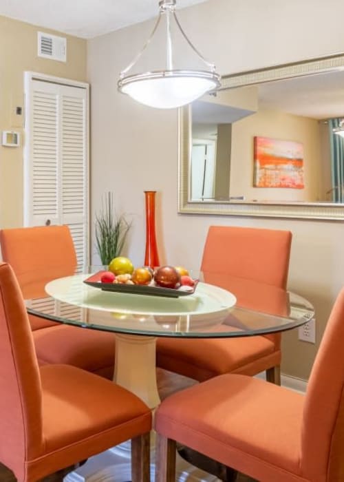 A dining table and chairs next to an apartments kitchen at Palmetto Place in Miami, Florida