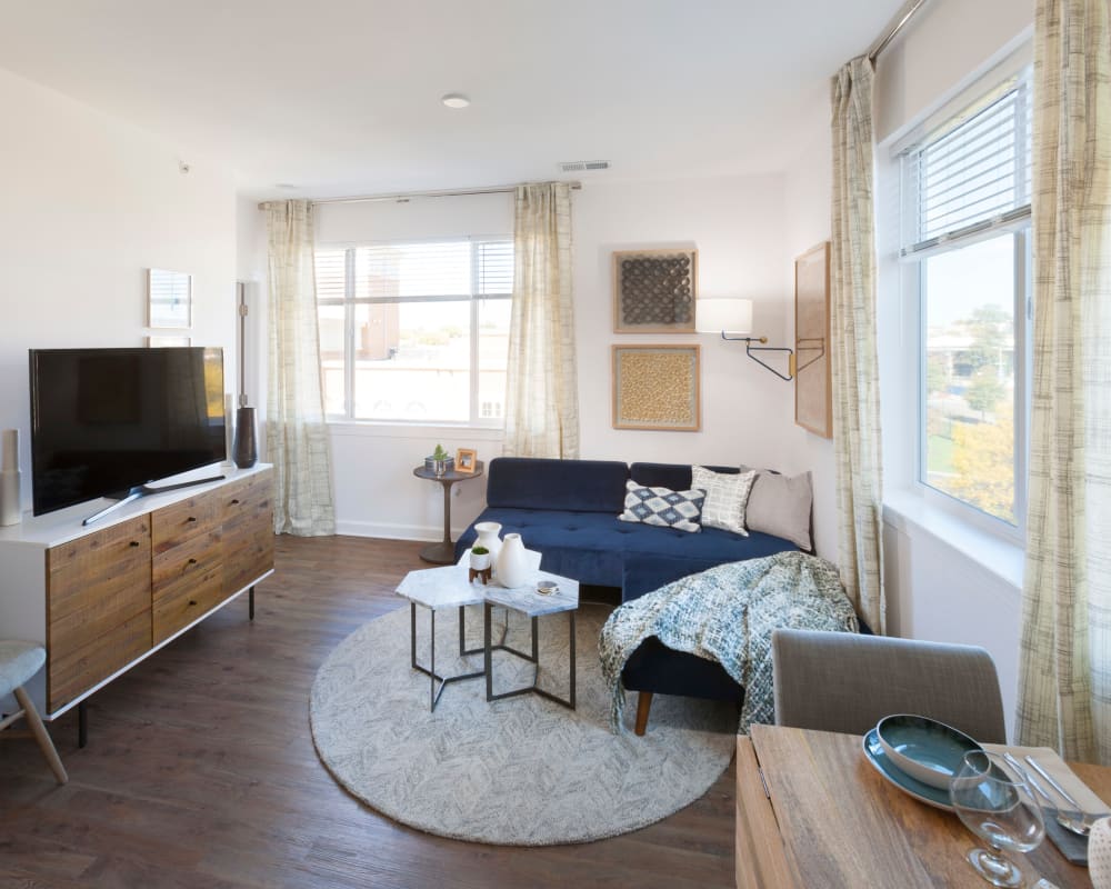 Well-decorated living area with hardwood flooring in a loft apartment home at The Bixby in Washington, District of Columbia