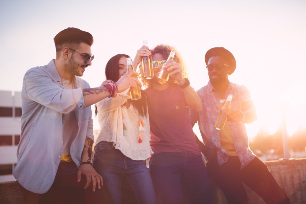 Residents enjoying a sunset drink on the rooftop deck at Derby in Phoenix, Arizona