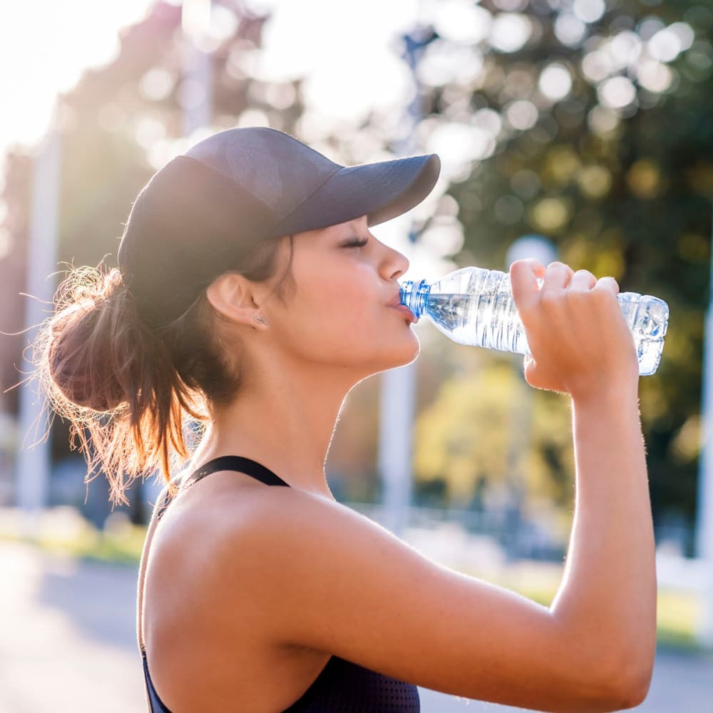 Resident taking a break from her morning jog to rehydrate near Oaks Lincoln Apartments & Townhomes in Edina, Minnesota