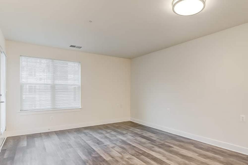Spacious living room with wood-style flooring at Homes on Quaker Lane in Sandy Spring, Maryland