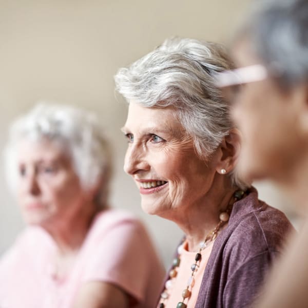 A resident listening to a talk at Pacifica Senior Living Menifee in Sun City, California.