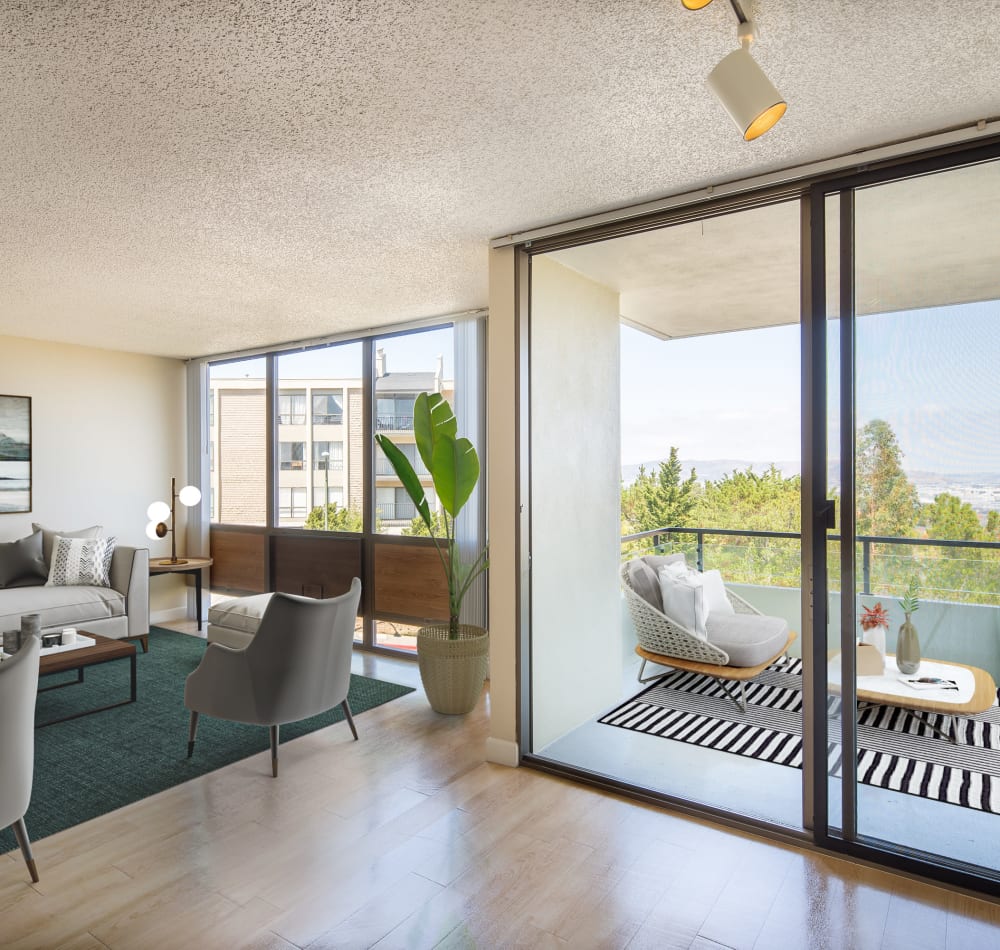 Balcony view with hardwood-inspired flooring at Skyline Terrace Apartments in Burlingame, California