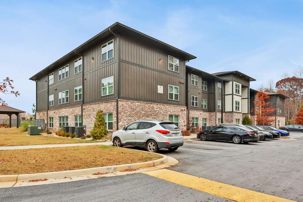 A view of the apartment buildings with car parking at Flats at Mount Zion in Stockbridge, Georgia