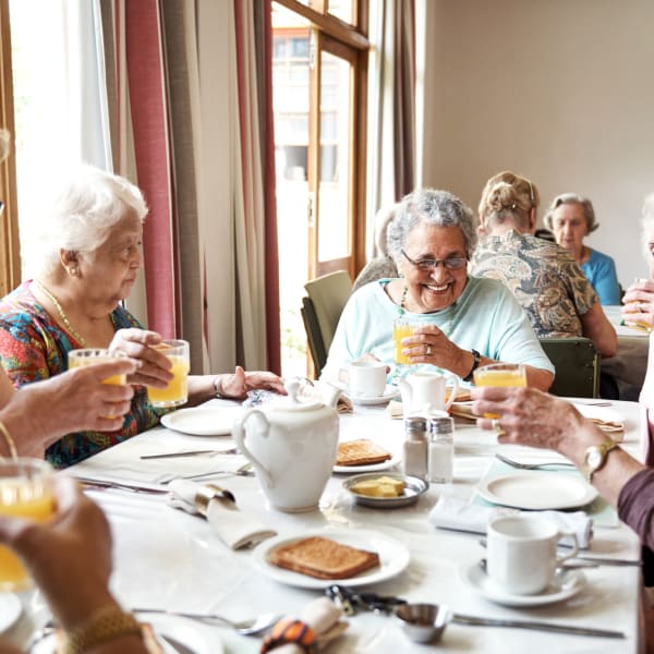 A group of residents enjoying a meal together at The Madison Senior Living in Kansas City, Missouri