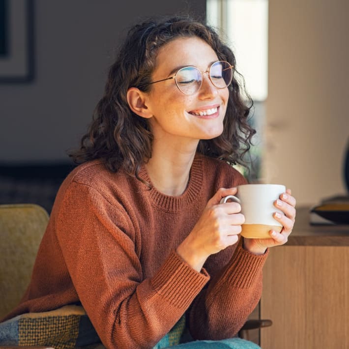 A happy resident sips coffee in her apartment at Mason Avenue, Alexandria, Virginia