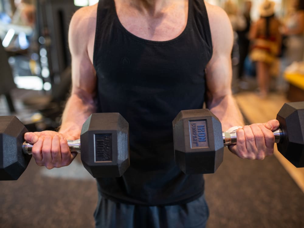 Resident staying in shape in the fitness center at The Reserve at Gilbert Towne Centre in Gilbert, Arizona