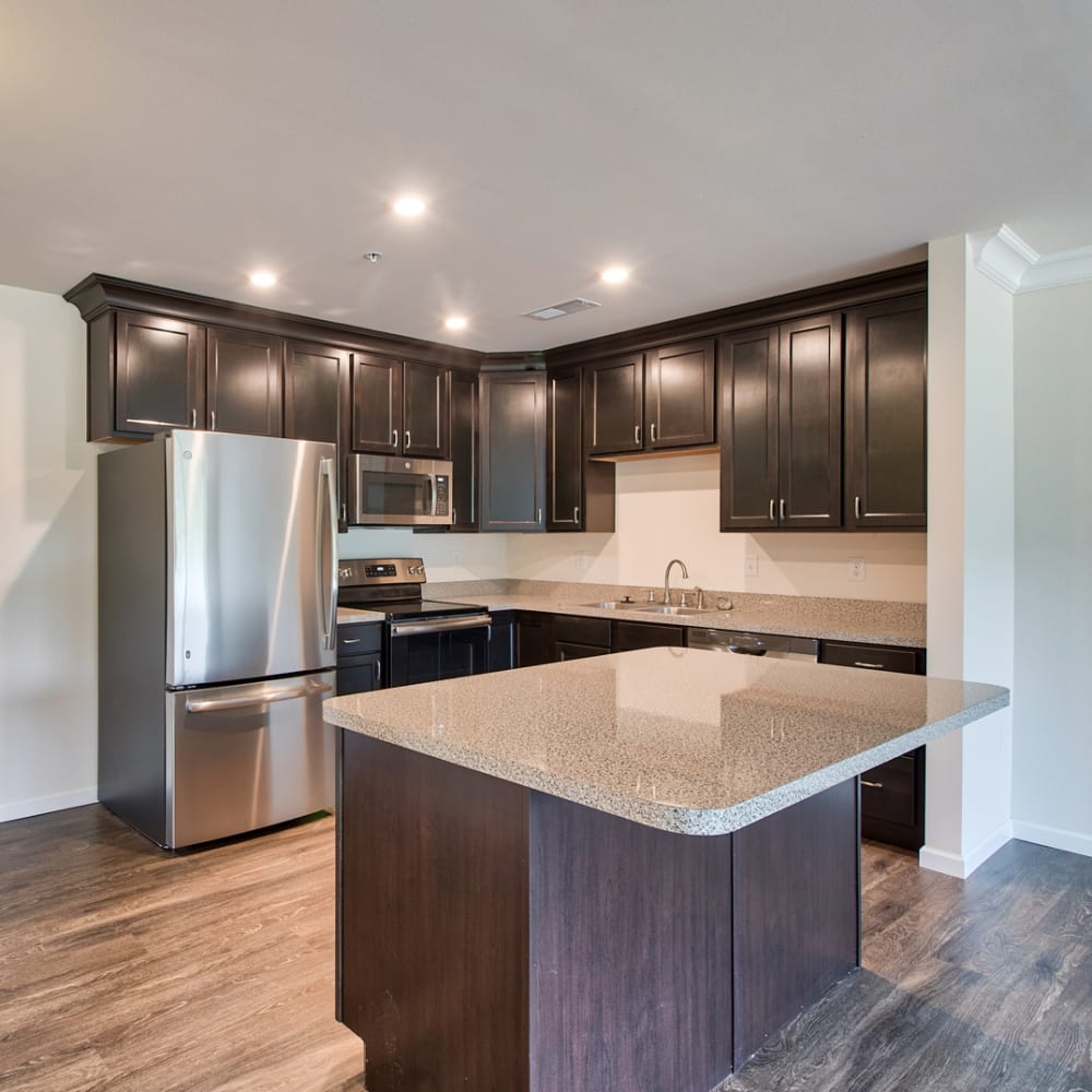 Kitchen with stainless-steel appliances and wood-style floor at Heritage Preserve, Hilliard, Ohio