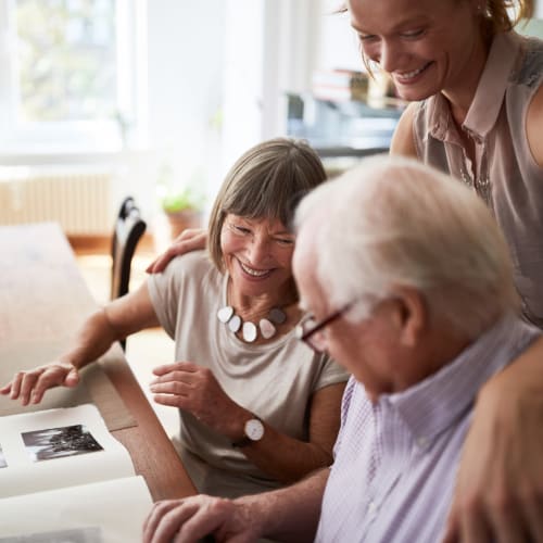 Resident couple looking at a photo album at Oxford Springs Tulsa Memory Care in Tulsa, Oklahoma