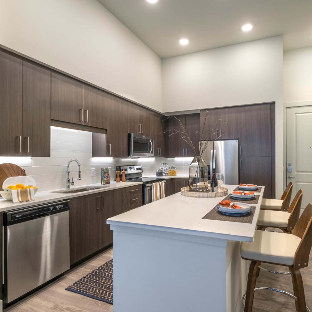 Custom wooden cabinetry and energy-efficient appliances in the kitchen at Hall Street Flats in Dallas, Texas