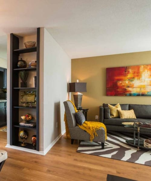 Living room with wood-style flooring at Vintage at 18th Street in Houston, Texas