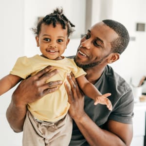 Happy resident father and son in their new home at Parkway Villas in Grand Prairie, Texas