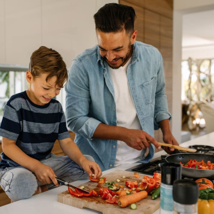 Father and son prepare a meal in their kitchen at Attain at Bradford Creek, Huntsville, Alabama