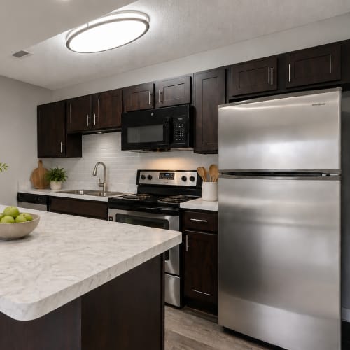 Modern kitchen with espresso cabinetry at The Lakes of Schaumburg Apartment Homes in Schaumburg, Illinois 