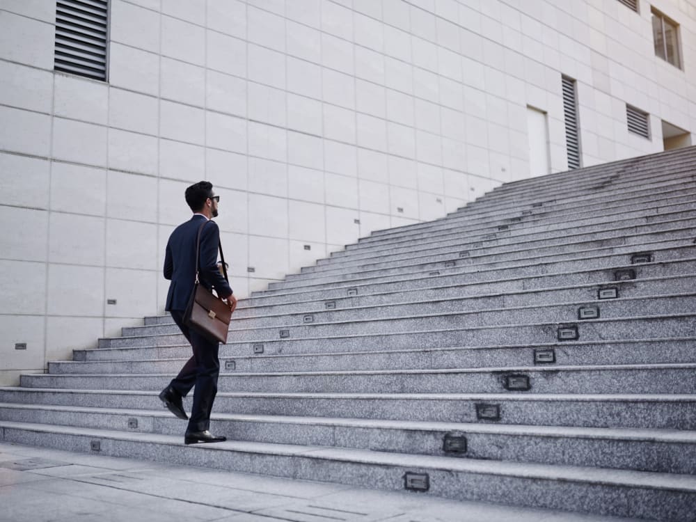 Resident walking up the steps to his downtown office near Skyline Terrace Apartments in Burlingame, California