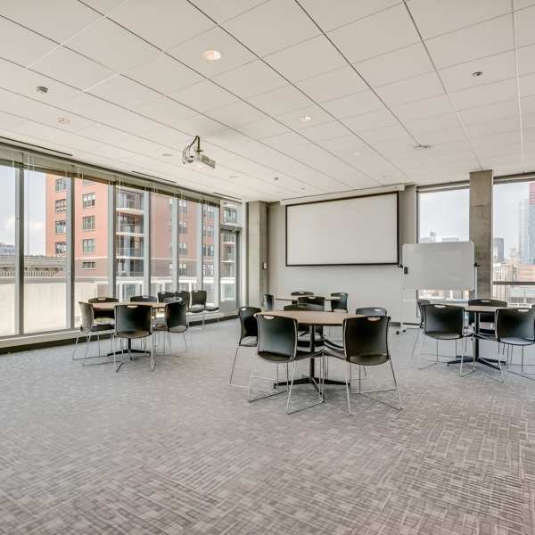 Interior view of a conference room with tables and chairs at The Flats at East West University in Chicago, Illinois 