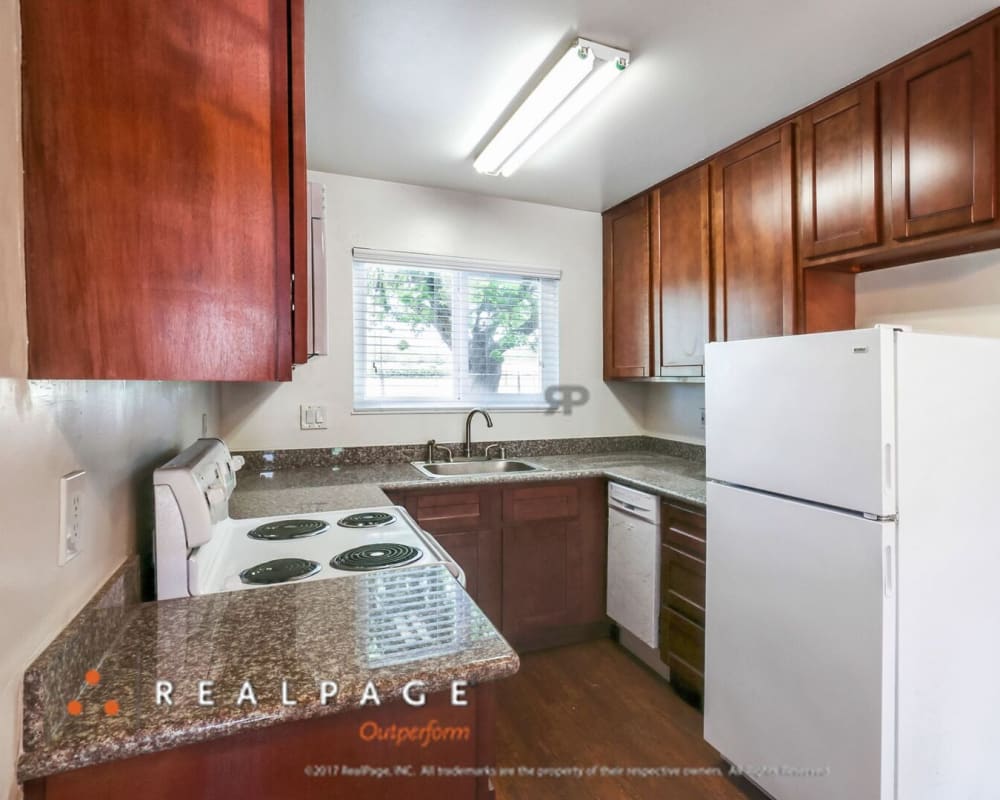 Model kitchen with granite countertops at Washington Townhomes in San Lorenzo, California