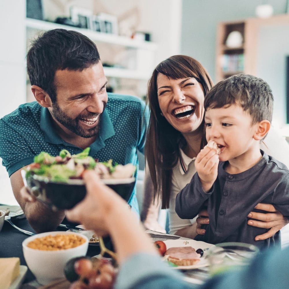 Family having family dinner at Peppertree Apartments in Winchester, Virginia