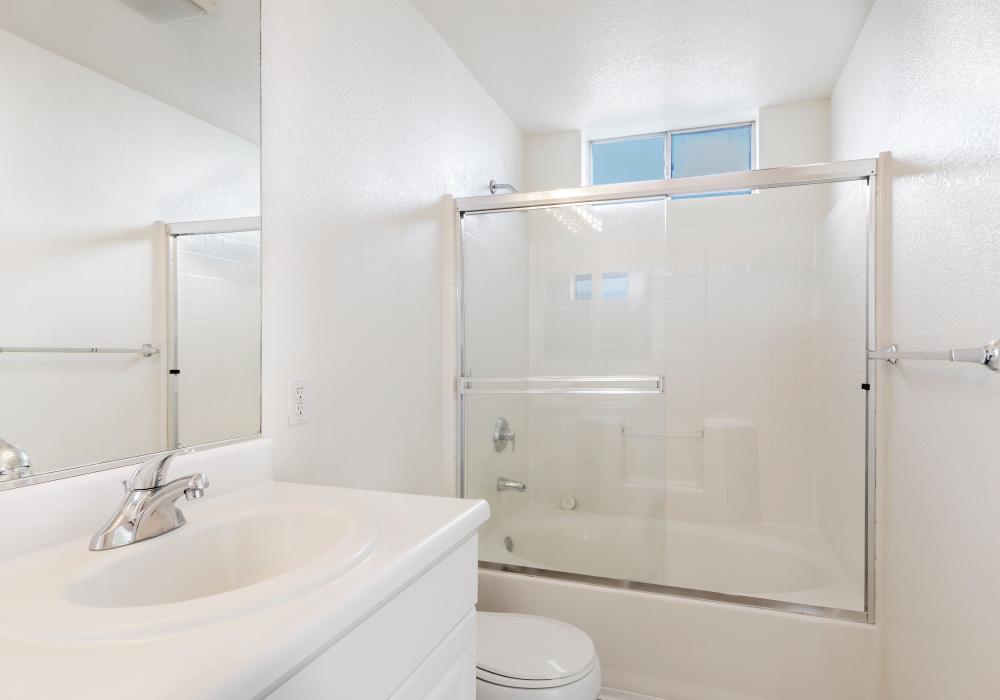 Bathroom with shower and tub at Park Hacienda Apartments in Pleasanton, California