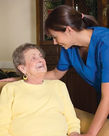 Caregiver at Burr Ridge Senior Living chatting with resident