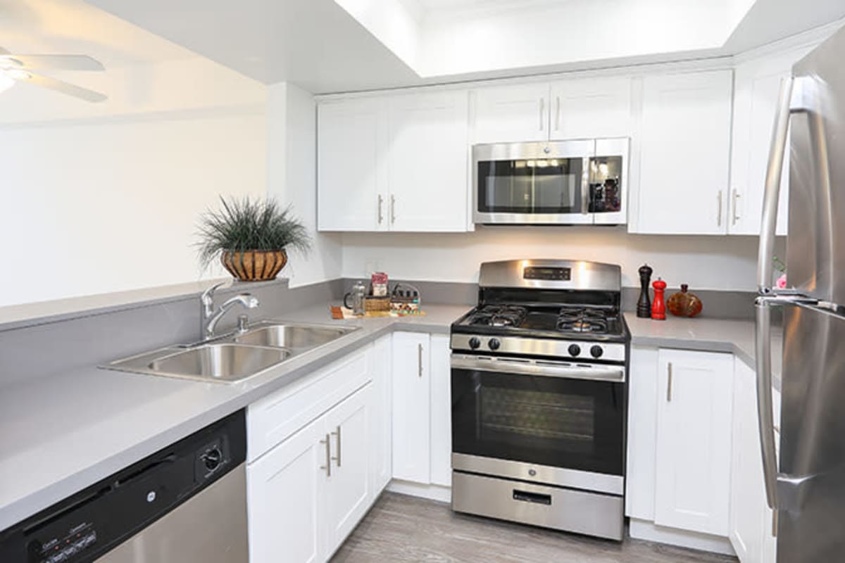 Kitchen with stainless-steel appliances at Kingsley Drive Apartments, Los Angeles, California