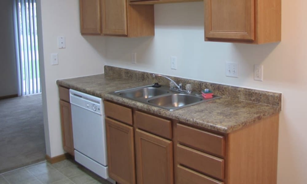 Kitchen with dishwasher at Indian Footprints Apartments in Harrison, Ohio